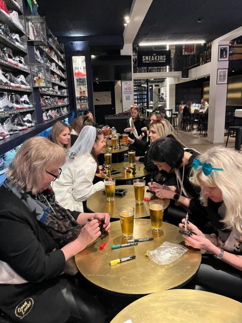 Brussels Tipsy Tour: Cocktail Making, Painting & Chocolates - Painting a Manneken Pis statue with a beer and shot