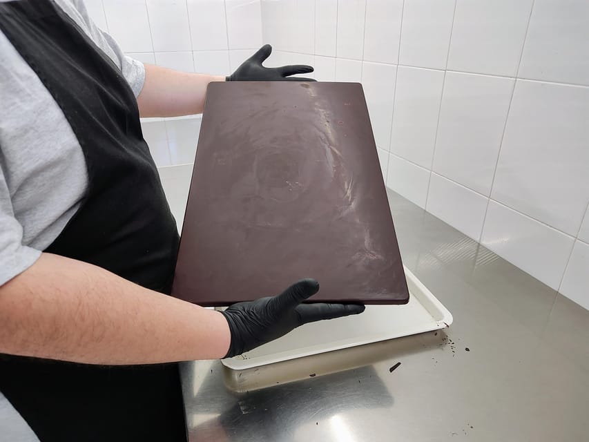 Chocolatier for a day: raw bean to bar chocolate in Modica - Grinding cacao with traditional stone equipment